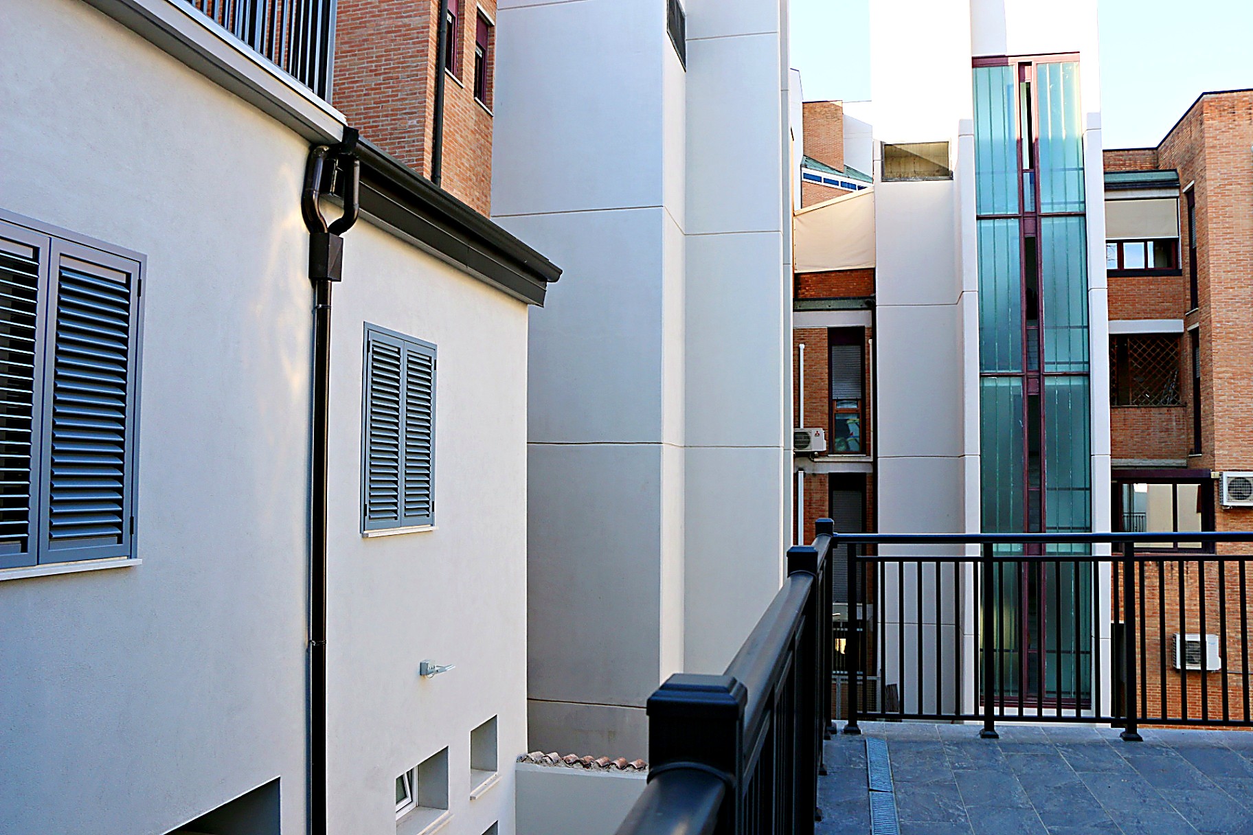 Internal courtyard with white walls and blue shutters